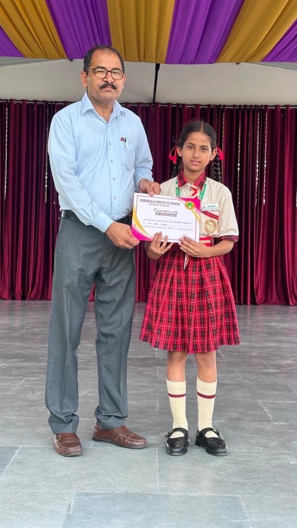 A student receiving a certificate of academic achievement on stage