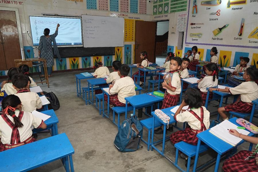 A teacher at the smart board with her class