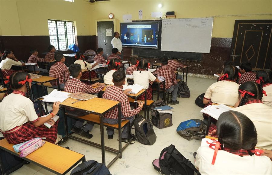 Students learning with a smart board in class