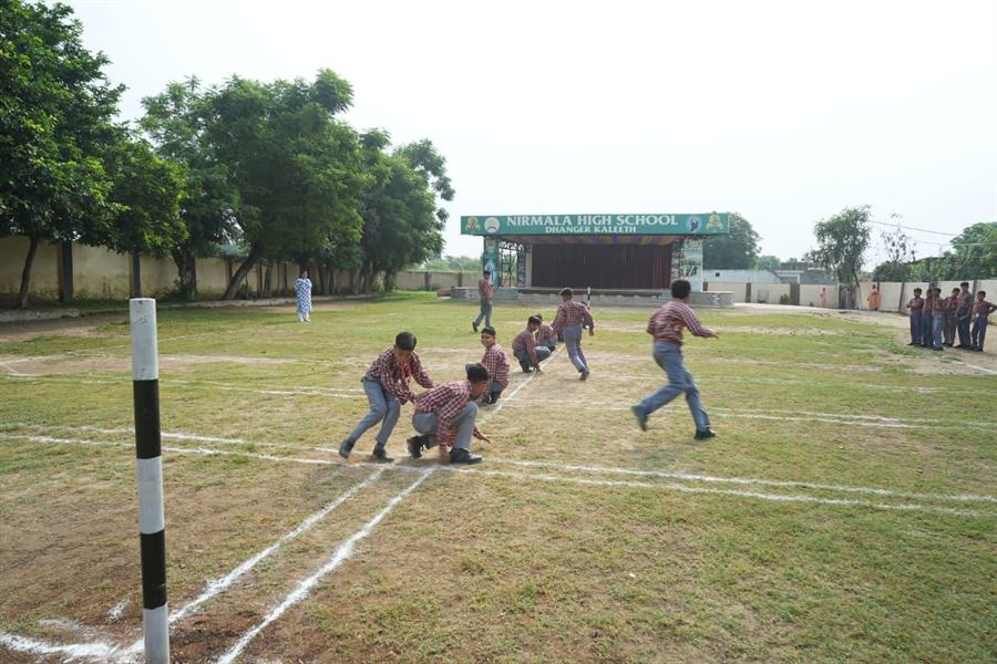 Students playing kabaddi on the playground