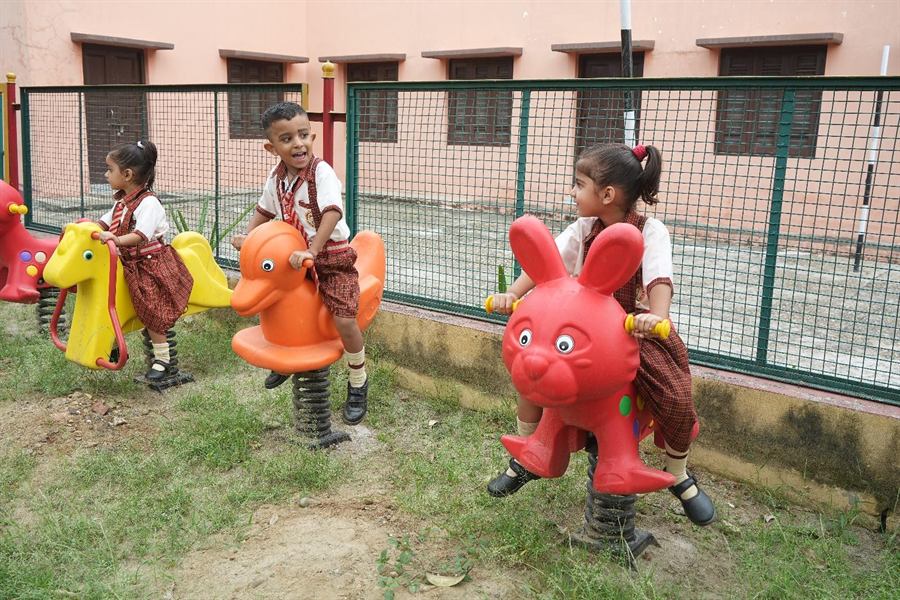 Young children on the rides in the children's park