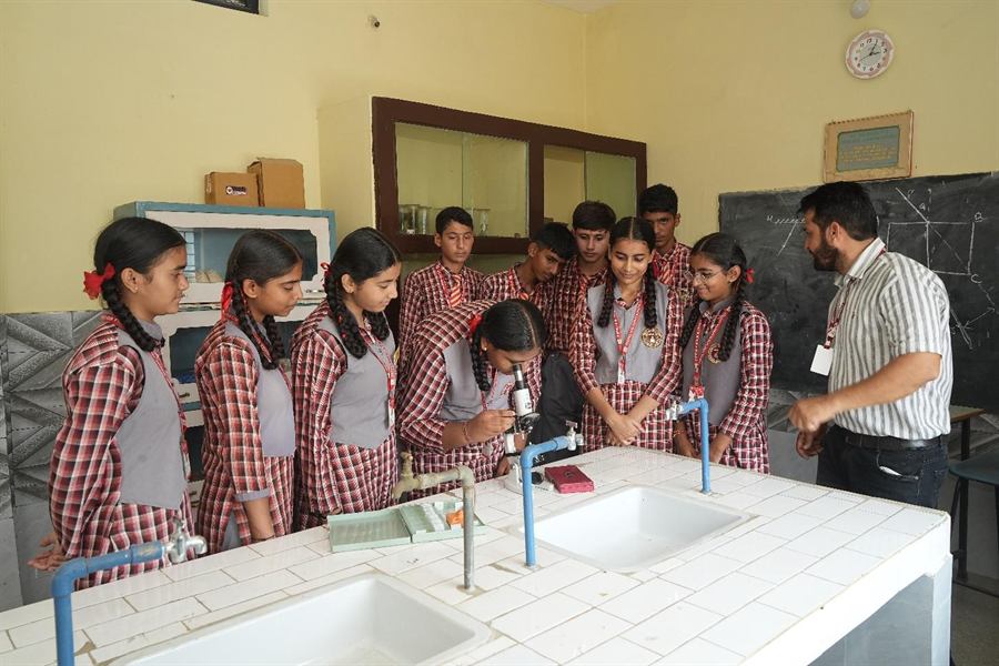 Students with their teacher in the science lab